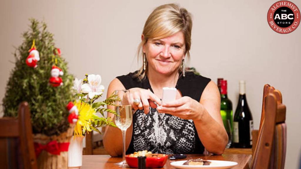Woman monitoring diabetes while dining with wine